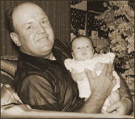 Daddy and Jann at Christmas.  Jann at 1 month old.